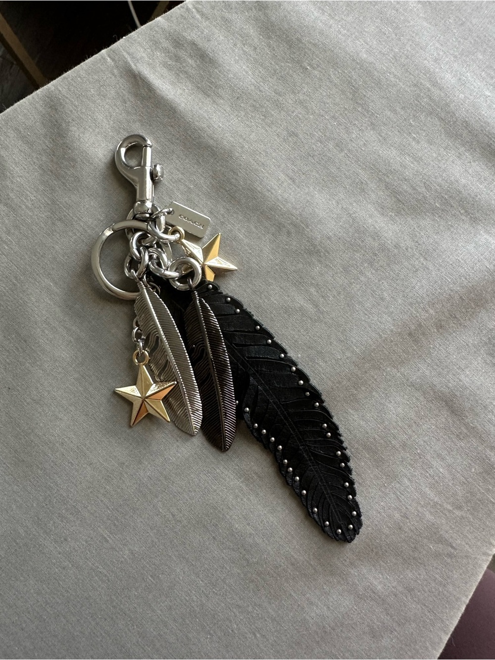 Coach Black Feather Keychain Charm with Mixed Metal Stars